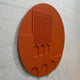 Arcuza Terracotta I Wood Carving Sandstone 3D Wall Art shown at an angle, with vertical fluted slats and recessed arches carved into the matte terracotta oval.