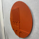 Angled side view of the Arcuza Terracotta I Wood Carving Sandstone 3D Wall Art by Giant Sculptures, showing carved vertical slats and arched recesses on a matte terracotta disc.