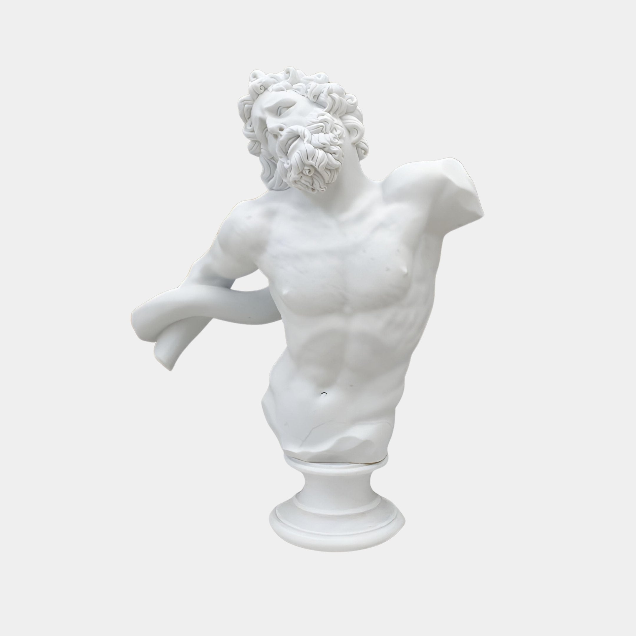 The Apollo Marble Torso Sculpture (80cm) by Giant Sculptures features a classical bearded man with curly hair, missing arms and torso parts, head tilted back and to the side on a round pedestal against a plain background.