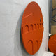 Side-angle view of the Arcuza Terracotta II Wood Carving Sandstone 3D Wall Art showing carved arches and offset window cut-out against a white wall.