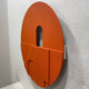 Arcuza Terracotta III Wood Carving Sandstone 3D Wall Art shown at an angled side view, displaying its circular form with arched cut-outs against a white wall.