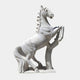 The 200cm Rearing Horse White Marble Outdoor Sculpture from Giant Sculptures depicts a dynamic horse on its hind legs, featuring intricate manes and a flowing tail. Its raised hooves and spirited expression add vitality against a plain background.