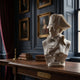 The Napoleon Military Marble Bust Sculpture - 65cm by Giant Sculptures sits on a wooden table in an elegant room with portraits, books, and a window—a striking piece of military history and refined decor.