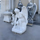 The stunning outdoor collection includes Giant Sculptures Crouching Grace Angel Marble Outdoor Sculpture, a 150cm kneeling winged figure, surrounded by robed figures with flowers and intricate reliefs on a paved surface next to a column-adorned building.