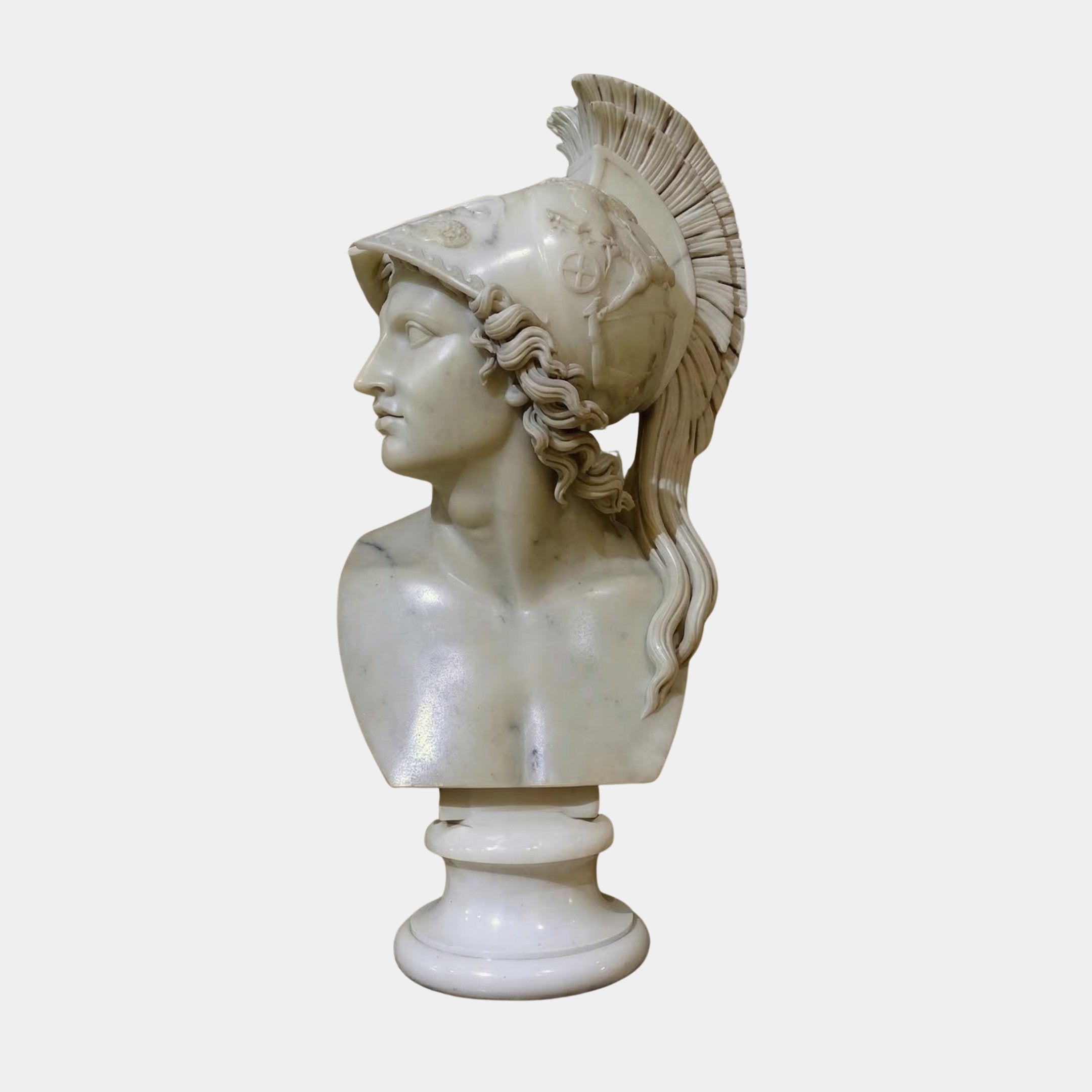 The Athena Marble Bust Sculpture - 65cm by Giant Sculptures shows a detailed profile of Athena with an ornate plumed helmet, set on a round pedestal against a plain white background.
