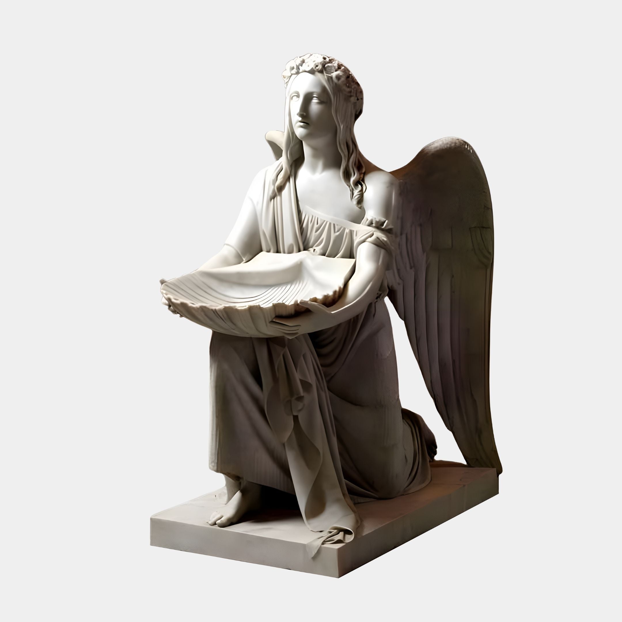 This Shell Offering Angel Marble Sculpture from Giant Sculptures features a 150cm white marble statue of a kneeling angel with wings, holding a large shell. The angel wears flowing robes and a floral wreath on its head, elegantly set on a rectangular base.