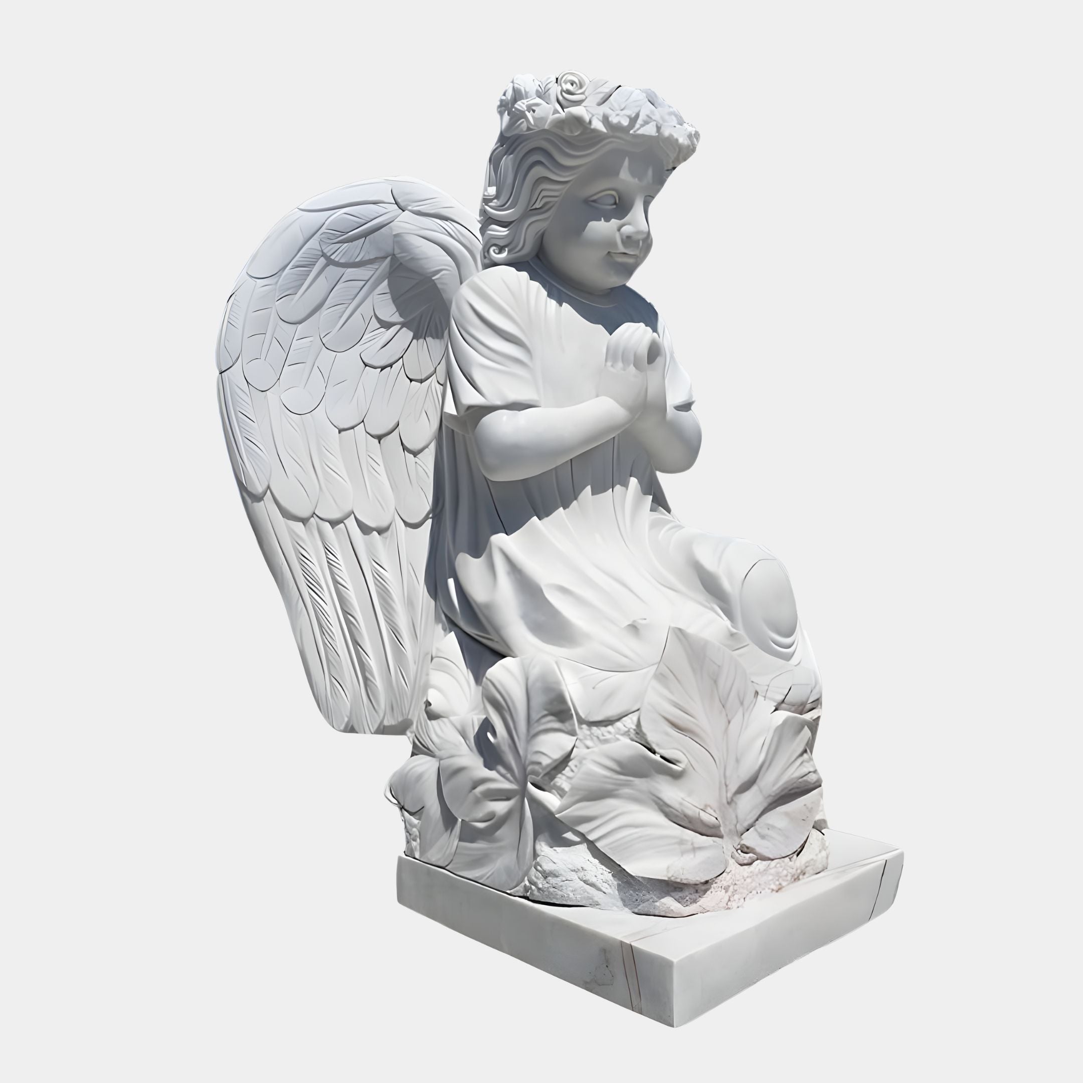 The Blossom Crown Cherub Marble Outdoor Sculpture by Giant Sculptures features an angel kneeling on a detailed base. The 100cm sculpture has large, detailed wings, curly hair, floral crown, and a flowing robe, with its hands together in prayer.