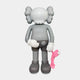 The Soft Grey Iconify Pink Furry Toy Figure by Giant Sculptures stands upright at 28cm, cartoon-like with X eyes and big gloved hands, holding a floppy pink character—ideal modern décor for any space.