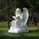 In a tranquil green park, the 120cm Heavenly Reading Angel Marble Outdoor Sculpture by Giant Sculptures sits on a cloud with poised wings. Hand-carved detailing adorns the angel as it reads, surrounded by gently shadow-casting trees in natures serenity.