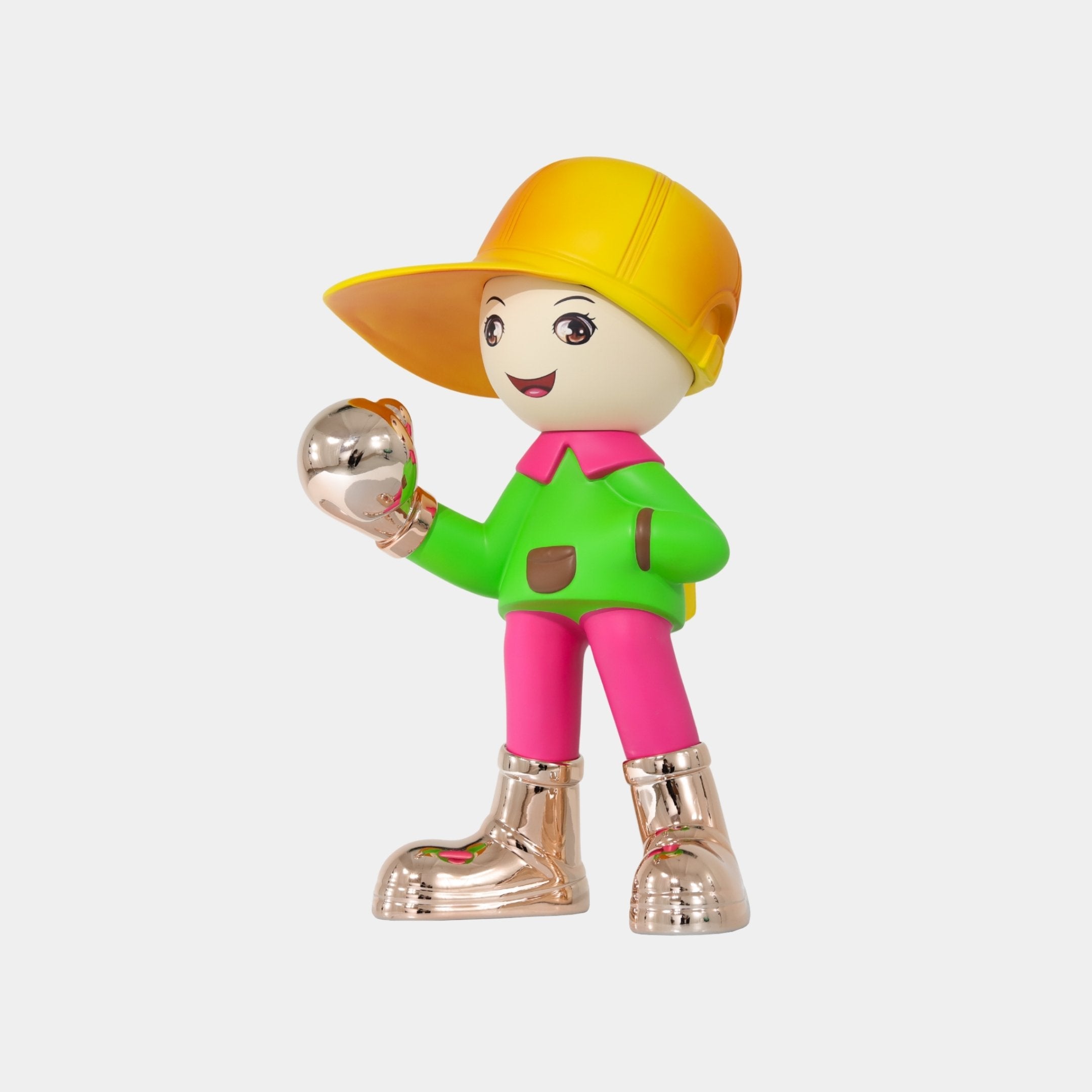 The Electroplated Boots & Fist Sunset Brimble Figure by Giant Sculptures features a colorful boy with a large yellow cap, green and pink outfit, reflective boots and gloves, smiling with a backpack while holding a silver ball.