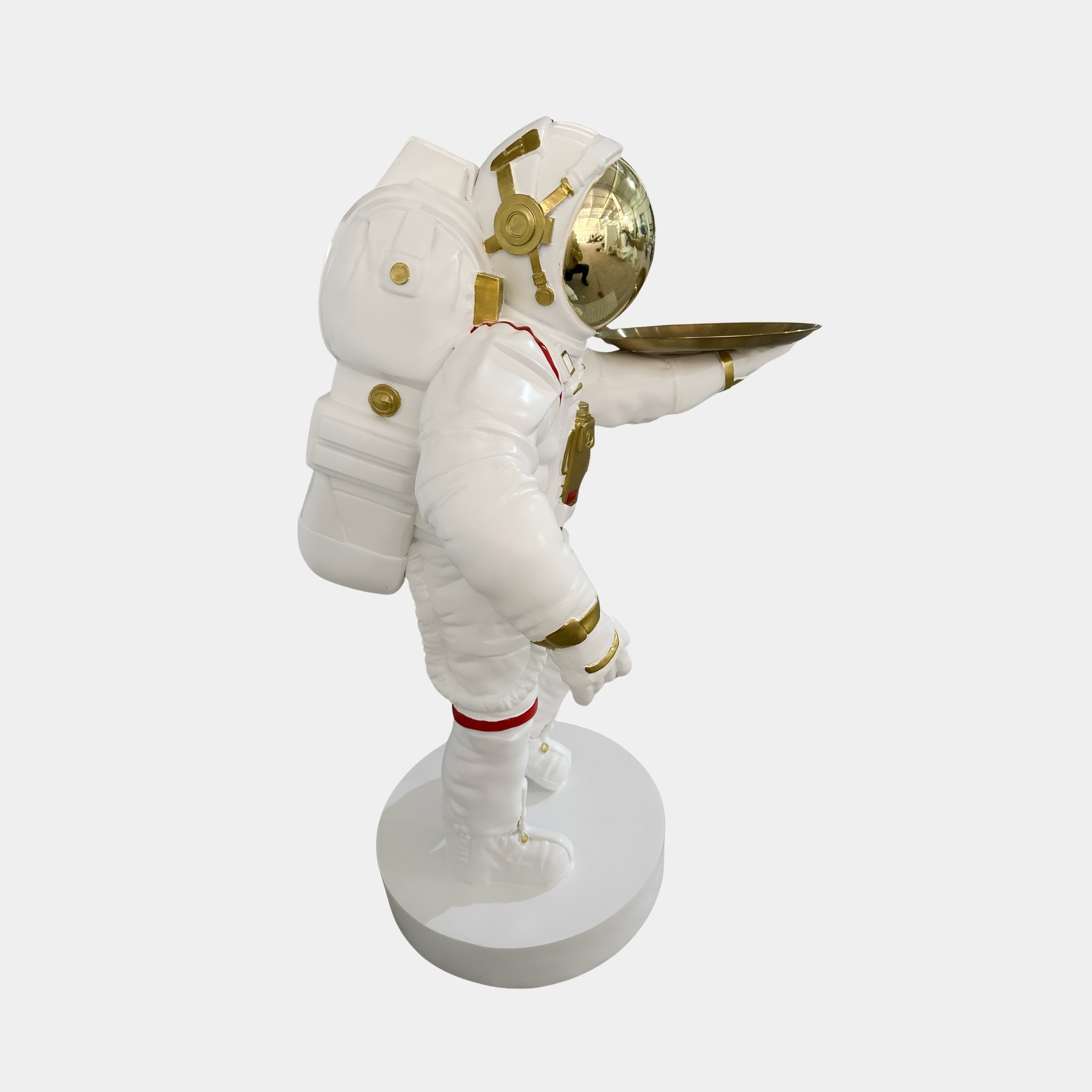 The Giant Sculptures White Space Astronaut Explorer Serve Sculpture (85cm) features gold details, a reflective gold helmet, and a gold serving tray, making it perfect modern space decor for any room.