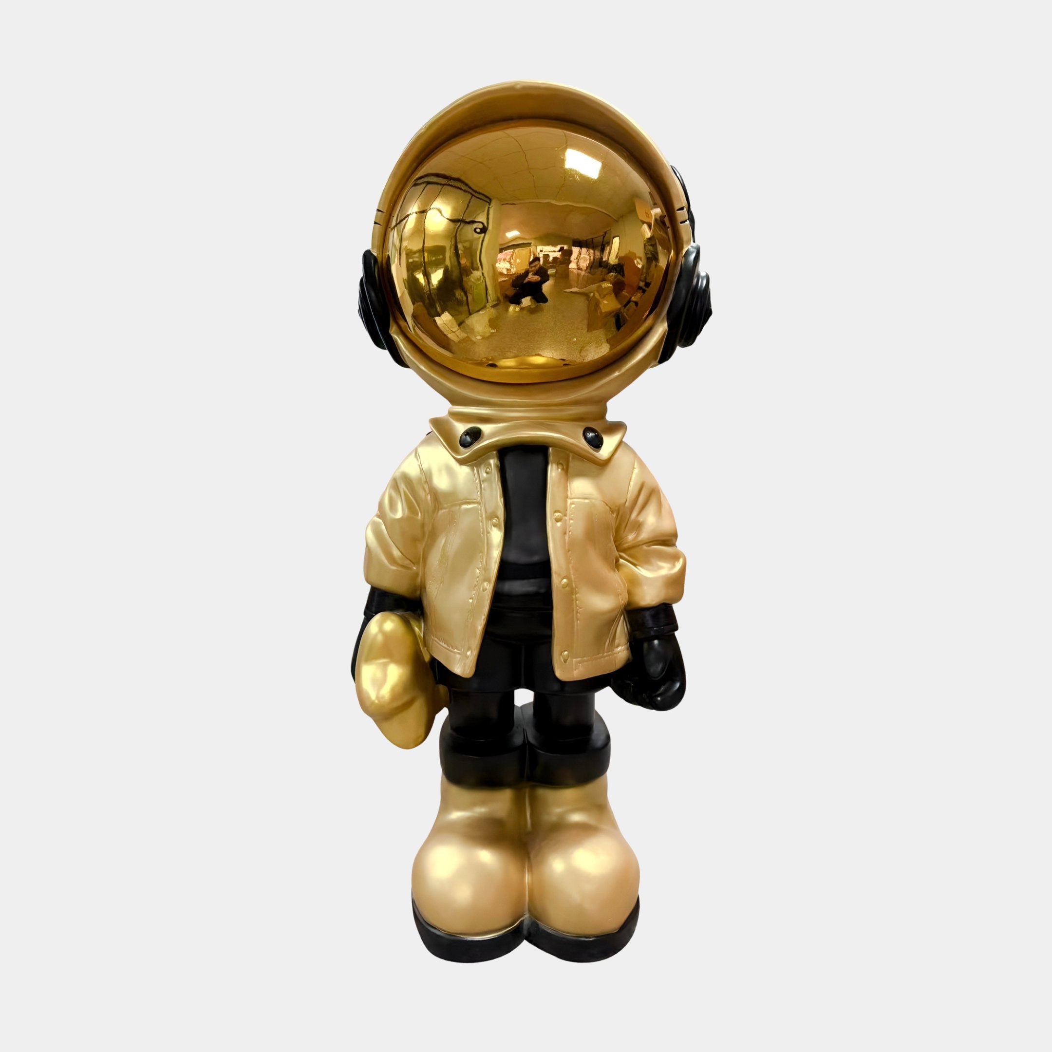 The Celestial Gold Astronaut Beats Sculpture - 70cm by Giant Sculptures features a gold helmet, black gloves and boots, and a gold jacket—ideal as unique astronaut décor or a bold space-themed ornament.