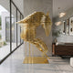 Rising Stallion Gold Steel Horse Sculpture by Giant Sculptures, 160cm rearing horse in stacked gold rings, displayed in a modern hallway beside a walnut console.