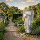 Giant Sculptures Cemetery Praying Angel Marble Outdoor Sculpture, 160cm white marble angel with detailed wings and flowing robes pouring water from a jug, set in a lush English garden.