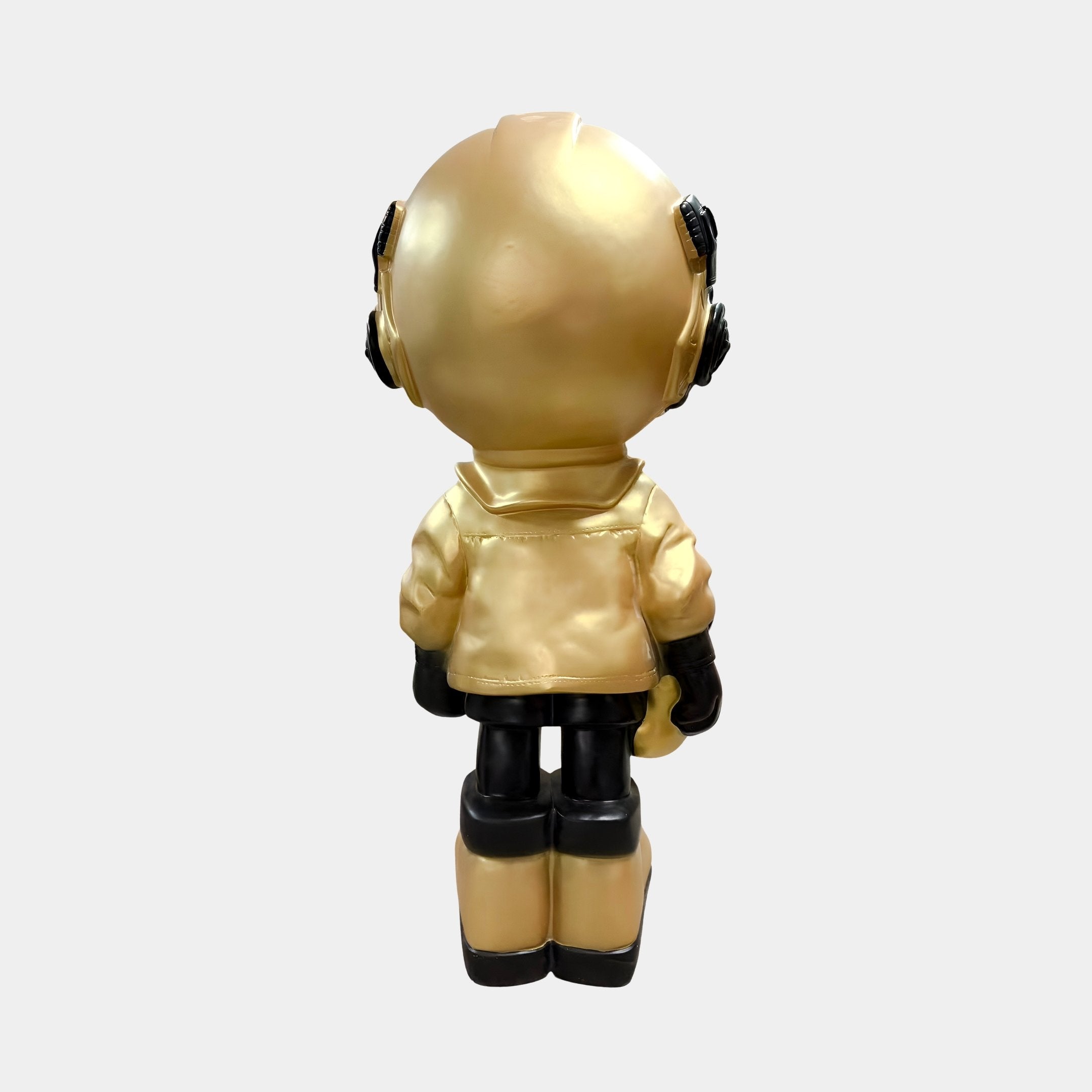 The Celestial Gold Astronaut Beats Figure - 36cm by Giant Sculptures features a reflective gold visor and black details, standing prominently with its large helmet and gloves—an ideal piece for space-themed décor.