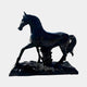 The Majestic Horse Black Marble Outdoor Sculpture by Giant Sculptures stands 220cm tall, featuring a detailed horse with one front leg raised, head turned slightly, and polished black marble finish—showcasing its mane, tail, and muscles.