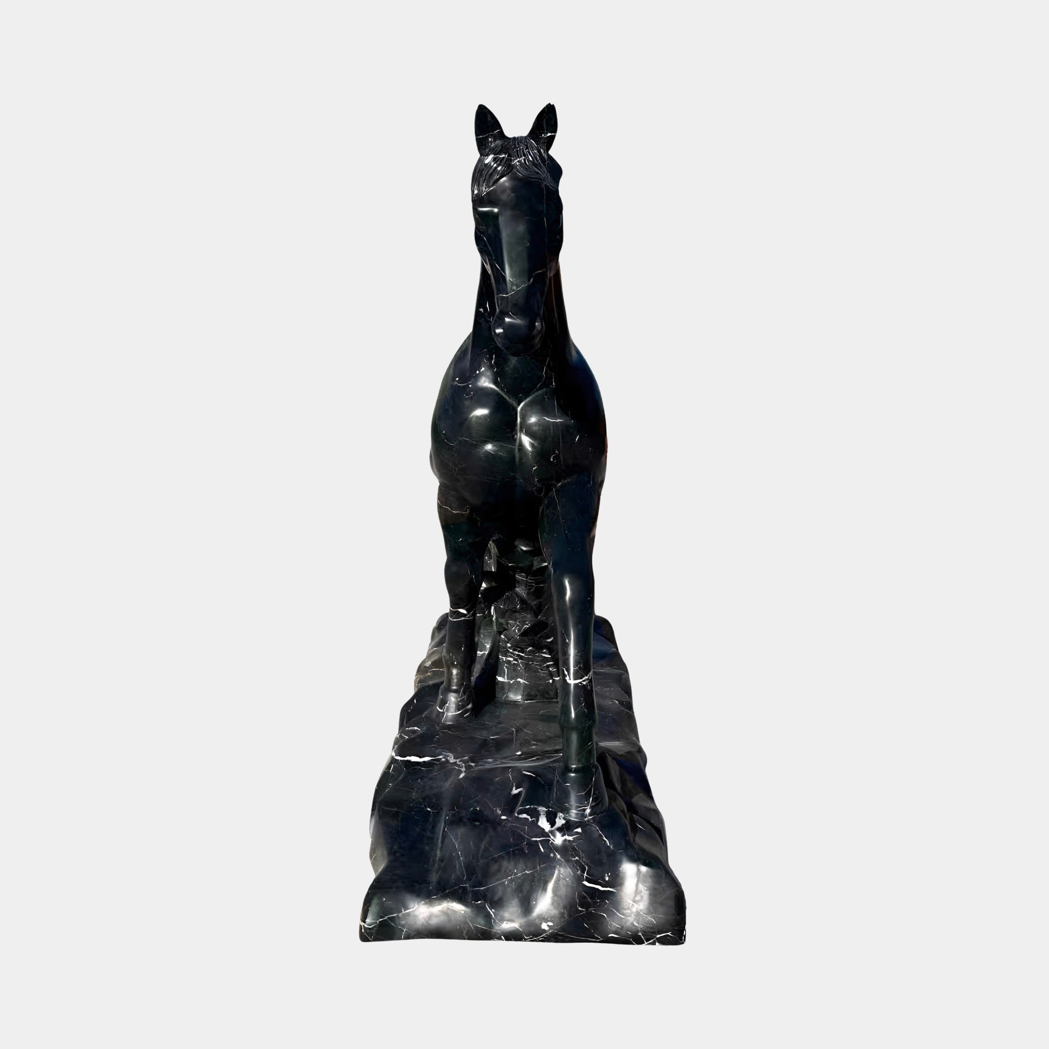 The Majestic Horse Black Marble Outdoor Sculpture by Giant Sculptures stands 220cm tall, featuring an elegant equestrian form on a rectangular base and is crafted from dark marble—perfect for outdoor display.