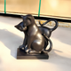 The Affectionate Cat Pair Marble Outdoor Sculpture by Giant Sculptures, standing 40cm tall, features two sleek cats—one sitting and the other leaning affectionately with gracefully curved tails—crafted elegantly in marble on a pedestal.