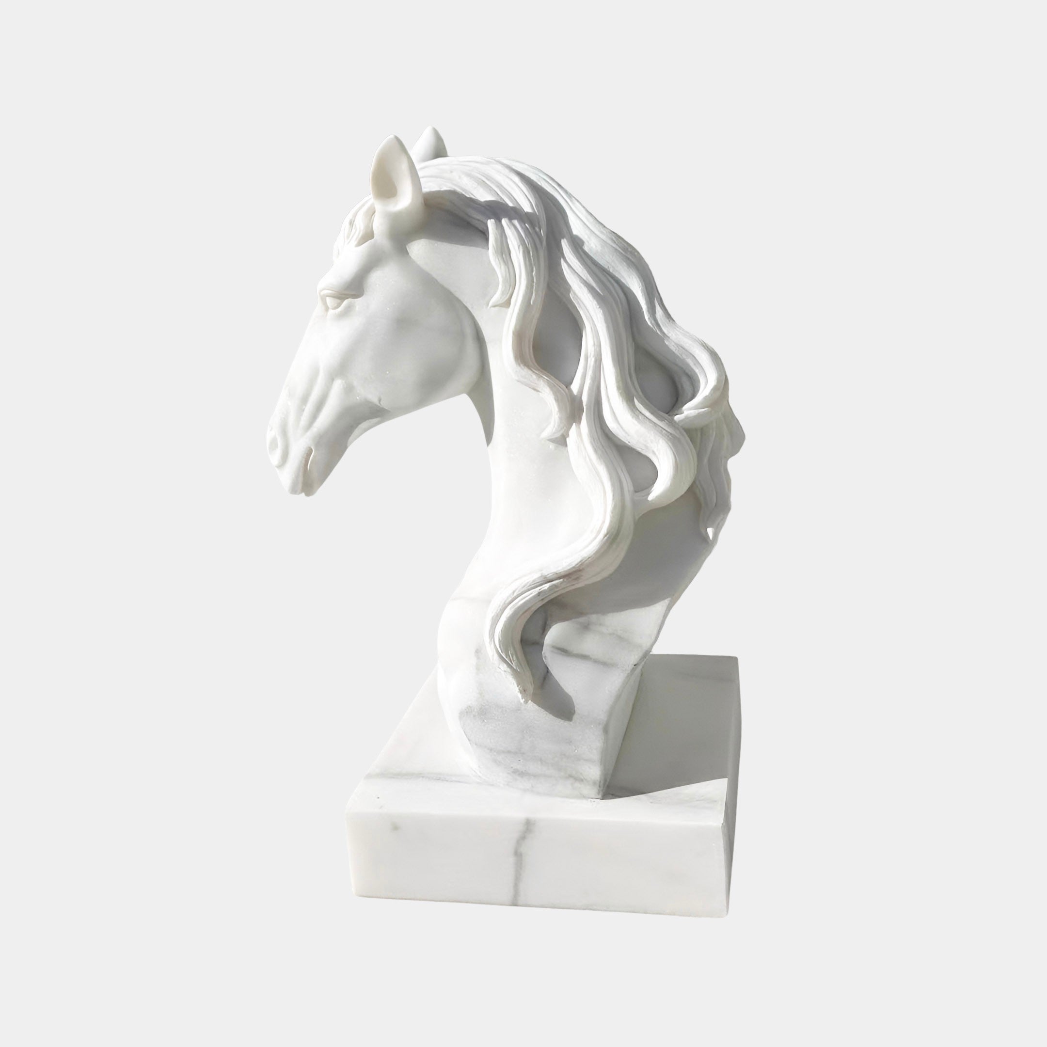 The Graceful Horse Head White Marble Outdoor Sculpture - 60cm by Giant Sculptures features a flowing mane and rests on a rectangular base, creating an elegant equestrian accent against a light gray background.