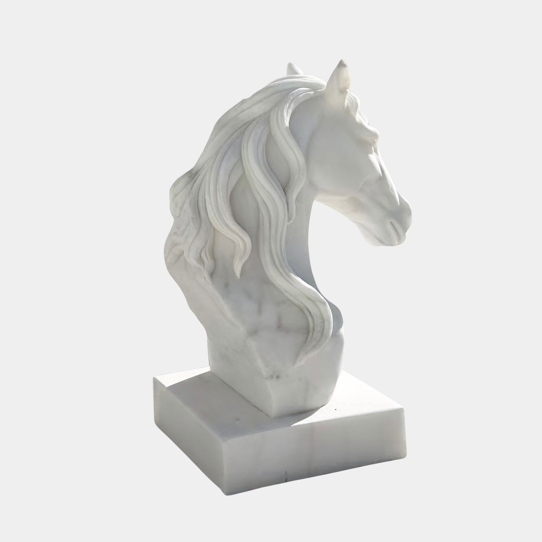 The Graceful Horse Head White Marble Outdoor Sculpture by Giant Sculptures (60cm) features a flowing mane and square base, making an elegant equestrian accent against a plain light gray background.