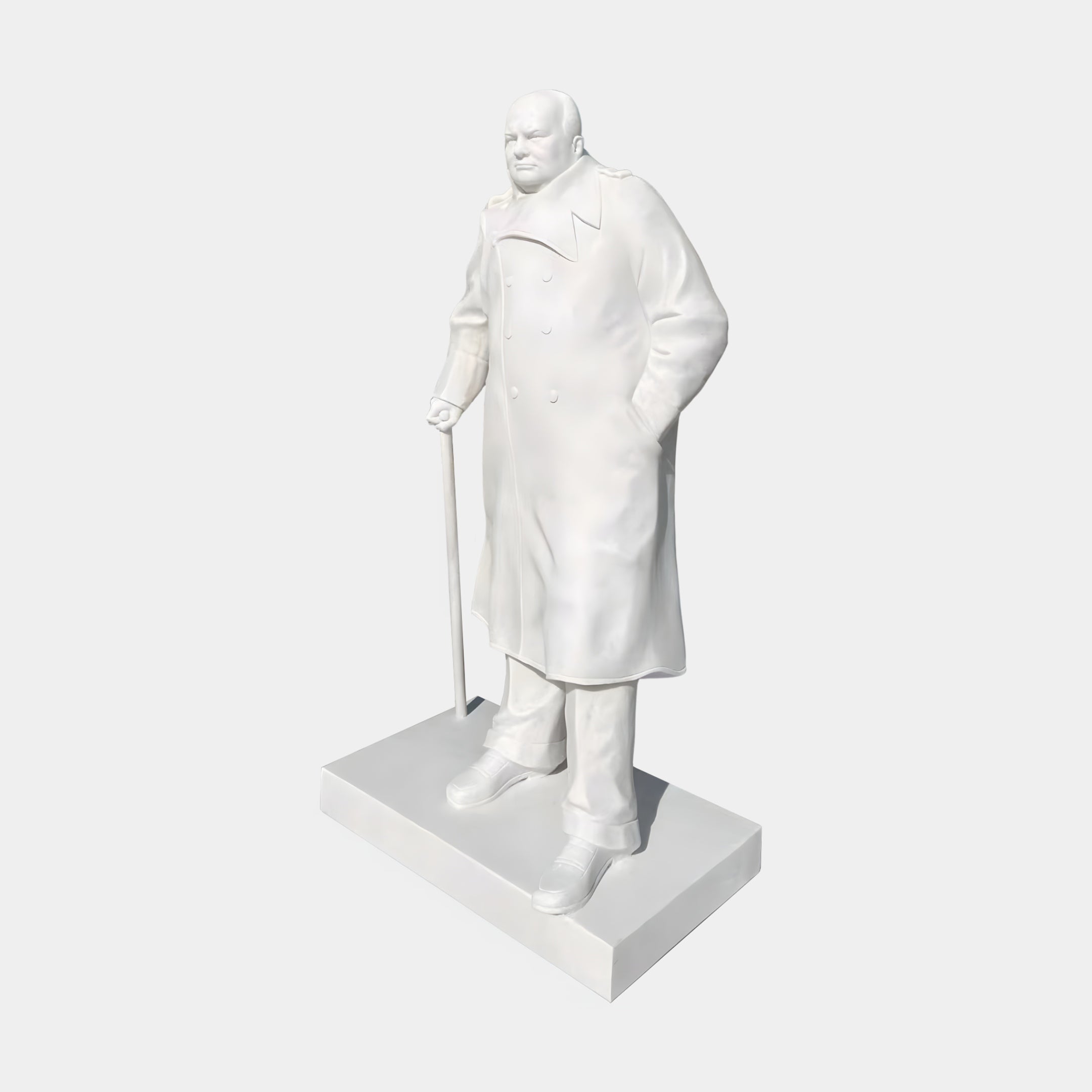 The Winston Churchill Marble Outdoor Sculpture - 195cm by Giant Sculptures features Churchill in a long coat, holding a cane on a rectangular base—perfect for outdoor display.