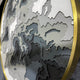 The Terranova Earth Green Round Wood Carving 3D Wall Art by Giant Sculptures features a layered, textured topographic design in shades of green, framed in a round gold border—bringing nature-inspired style to any room.