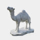 The Saddled Standing Camel Marble Outdoor Sculpture by Giant Sculptures, standing at 220cm, features a white marble camel with a decorative saddle and intricate hand-carved details, poised in an upward-looking stance on a textured base.
