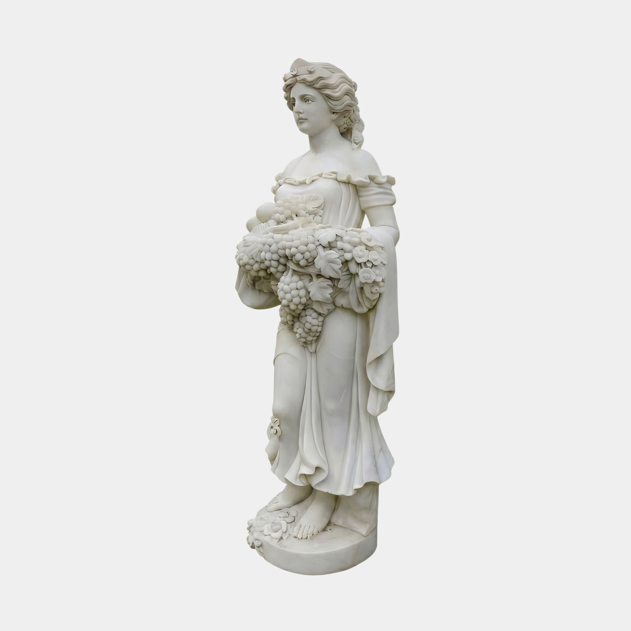 Goddess of Abundance 160cm white marble sculpture by Giant Sculptures, depicting a robed woman with floral crown holding a cornucopia of grapes and fruit.