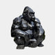 The Onyx Crouching Gorilla Marble Outdoor Sculpture by Giant Sculptures boasts shiny black surfaces and angular facets, offering a sleek, modern appearance that enhances any space with its geometric design.
