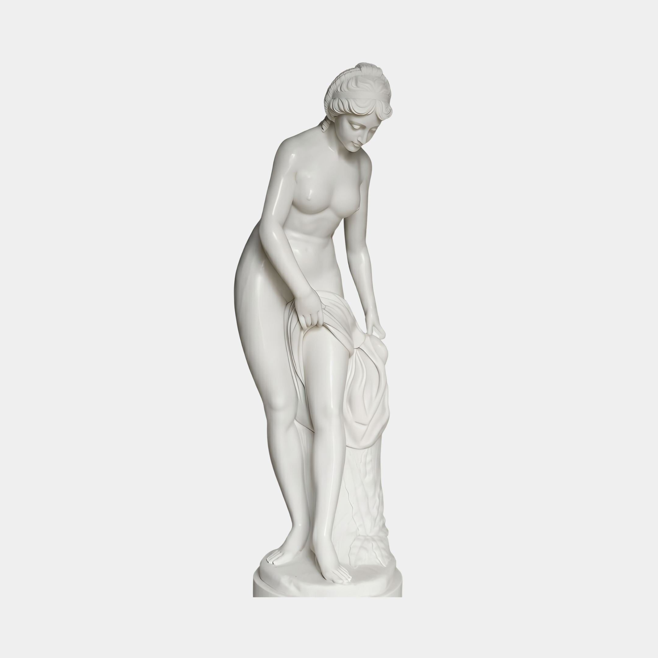 Standing Nude Bather Marble Sculpture by Giant Sculptures, 160cm tall, depicting a woman leaning forward holding draped cloth beside a rocky base, on plain background.