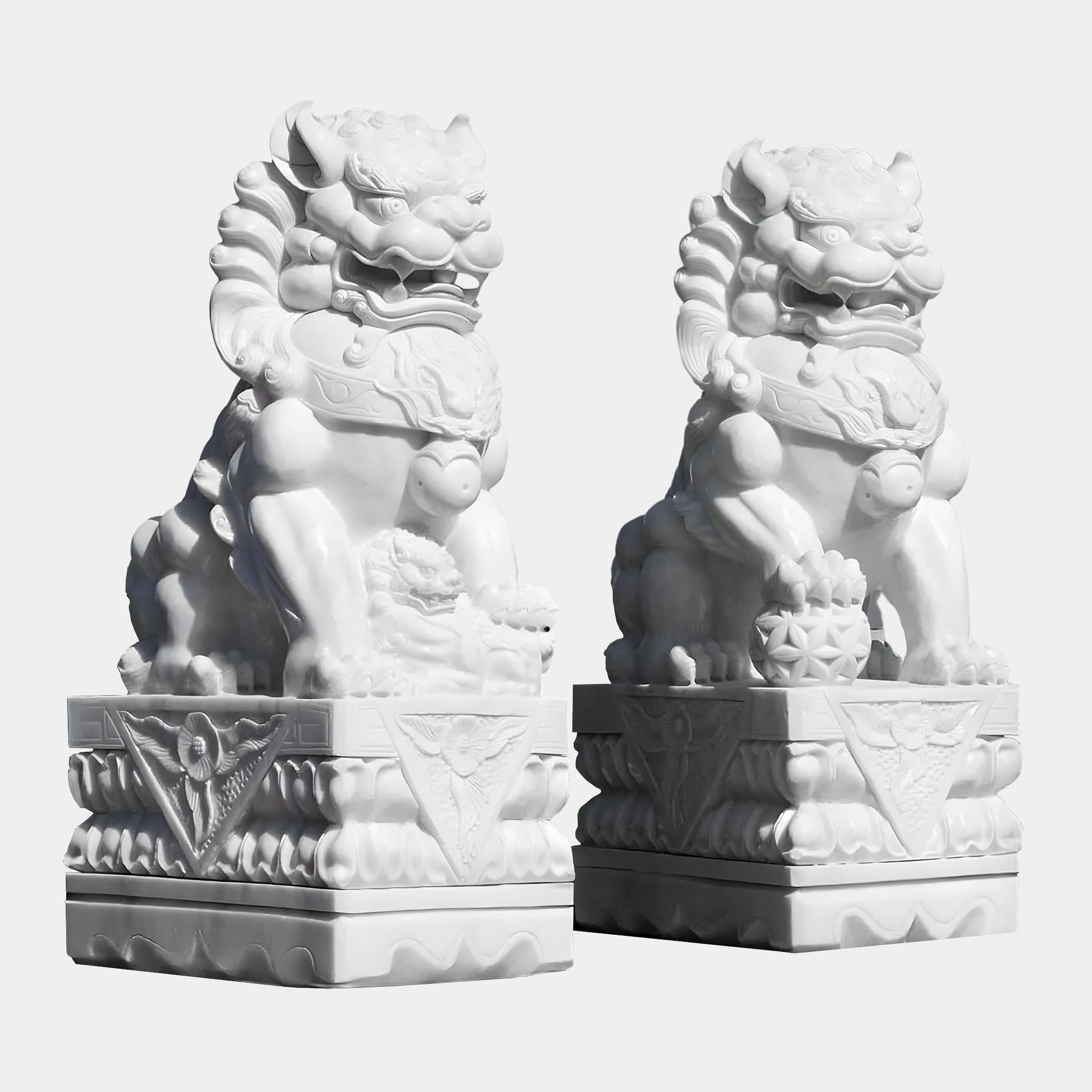 The Chinese Guardian Lion II Marble Outdoor Sculpture by Giant Sculptures stands 120cm tall, featuring intricately hand-carved details, flowing manes, and one lion playfully holding a ball under its paw on an ornate rectangular pedestal.