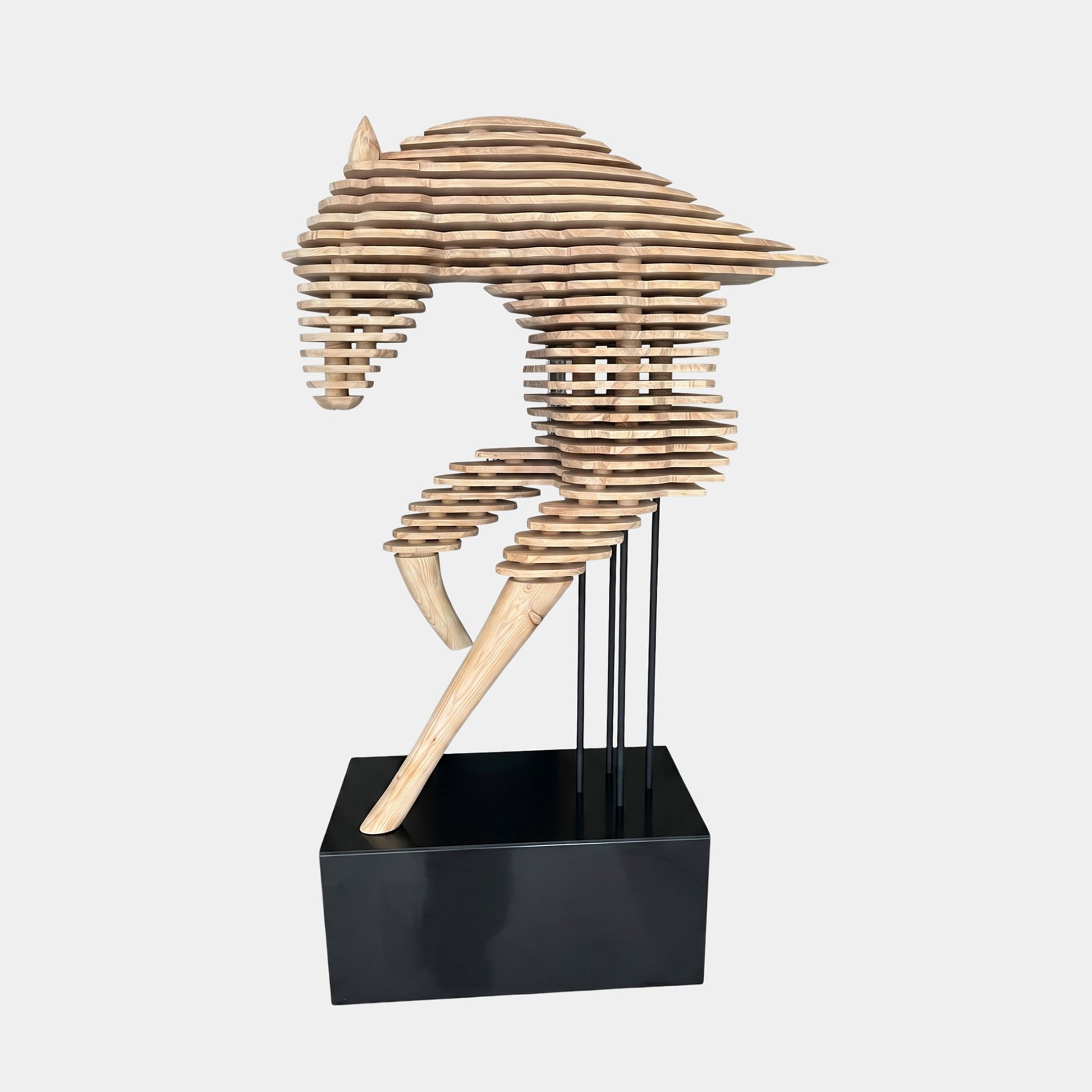 Rising Stallion Wood Horse Sculpture by Giant Sculptures, 160cm, side view of a leaping horse built from stacked natural wood slabs on a black base.