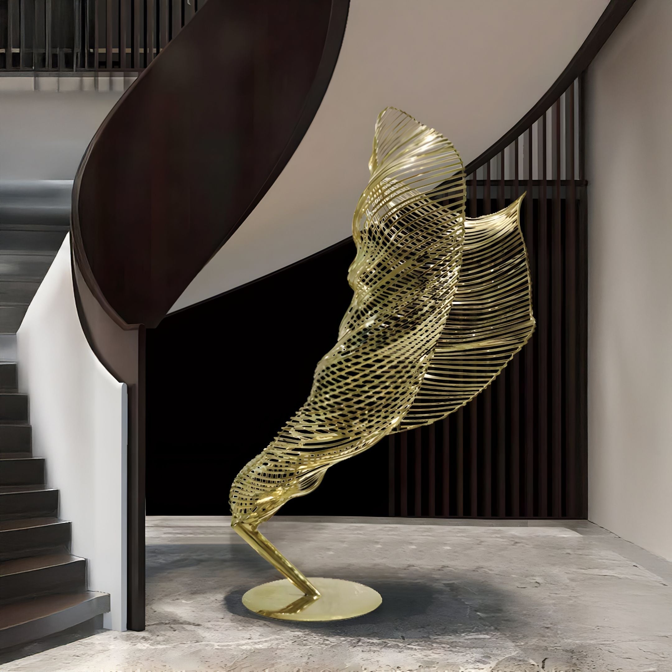 A contemporary gold sculpture, the "Tornado II Gold Organic Steel Sculpture - 155cm" by Giant Sculptures, stands on a round base beneath a curved staircase. Its intricate design of twisted metal beautifully complements the neutral tones and sleek finishes of the modern interior.