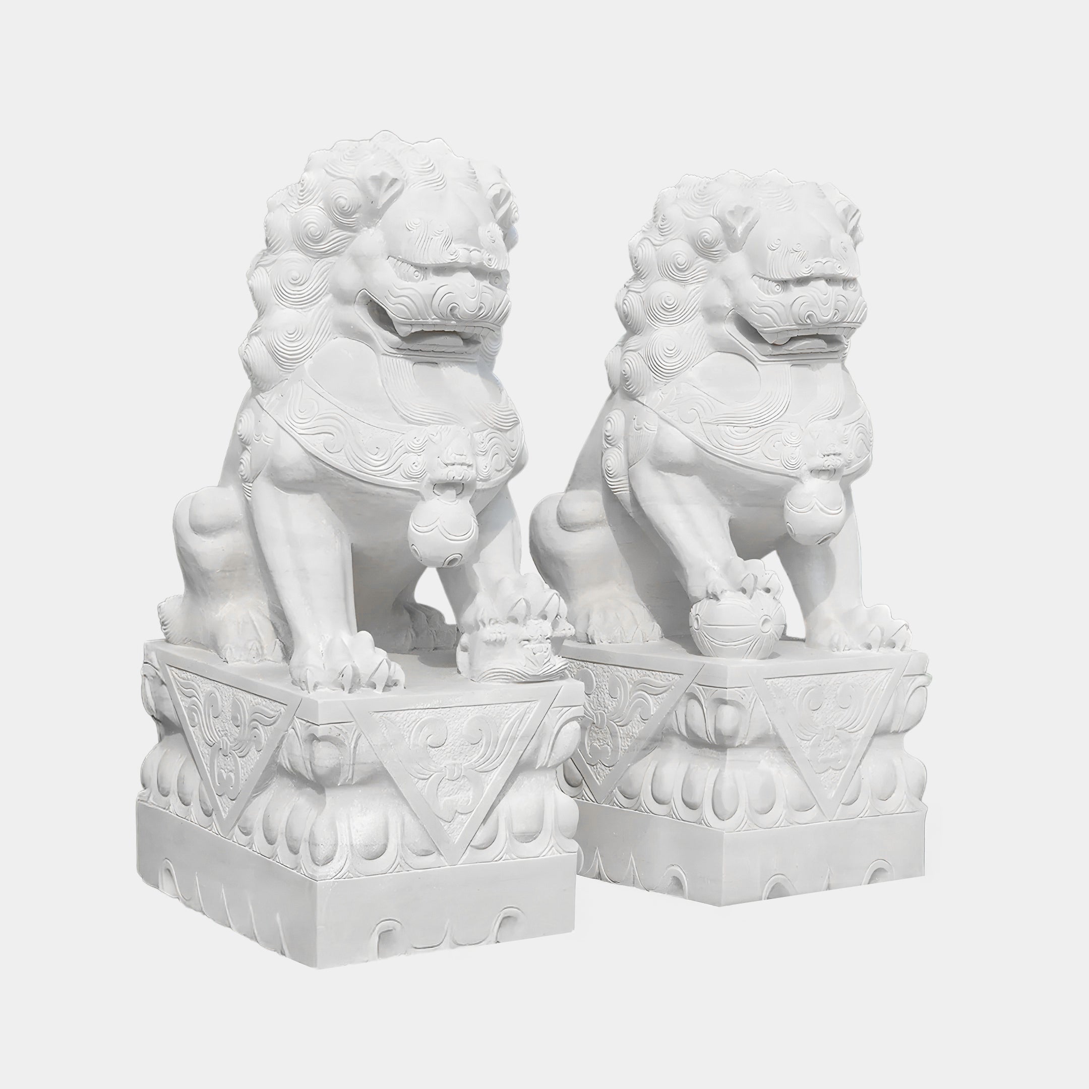 Two hand-carved Chinese Guardian Lion IV sculptures by Giant Sculptures stand on ornate pedestals. The 180cm marble lions have intricate carvings, each holding a ball under one paw, with fierce expressions and detailed manes, embodying traditional marble outdoor artistry.