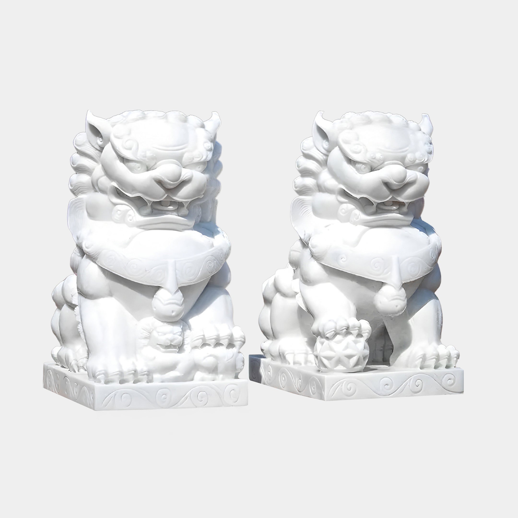 The Chinese Guardian Lion VII Marble Outdoor Sculpture by Giant Sculptures, standing at 120cm, showcases two white lions with fierce expressions, detailed manes, and curled tails on intricately carved bases. Their bodies have decorative patterns, each holding a ball under one paw.