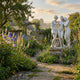 The Three Graces 100cm marble sculpture by Giant Sculptures, three intertwined female figures on a carved plinth, set in a cottage garden with foxgloves and delphiniums.