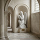 The Giant Sculptures Crowned Prayer Angel Marble Outdoor Sculpture (180cm) kneels with folded hands in an arched stone alcove, its marble surface glowing as sunlight streams through a large window onto the patterned tile floor.