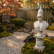 Athena Marble Bust Sculpture by Giant Sculptures in white marble with crested Corinthian helmet, displayed on a pedestal in an autumn Japanese garden with fallen maple leaves.