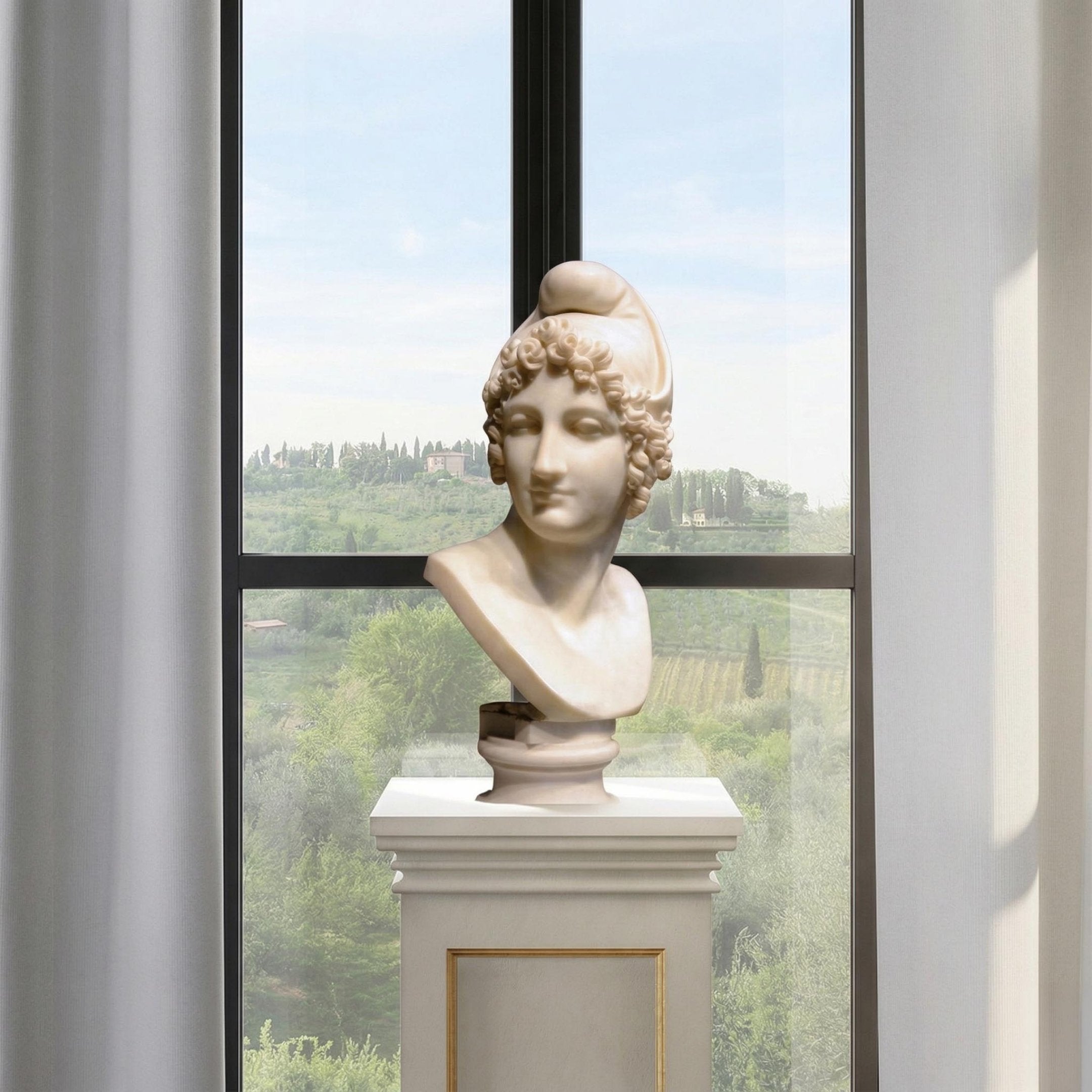 The Female Marble Bust With Cap Sculpture - 50cm by Giant Sculptures is displayed on a pedestal before a tall window, showcasing lush green countryside and trees outside.