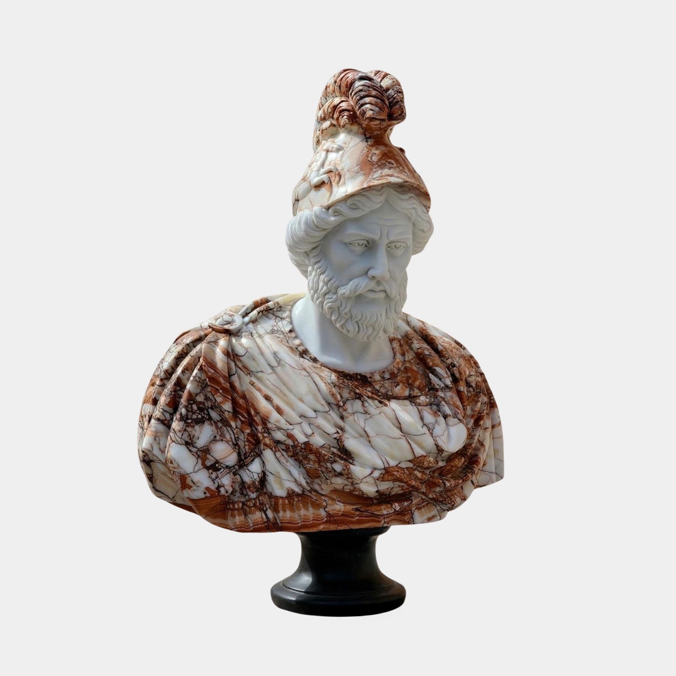 The Bearded Male Marble Bust Sculpture - 90cm by Giant Sculptures features a man in an ornate helmet and draped clothing, carved from natural brown and white veined marble, elegantly displayed on a black pedestal.