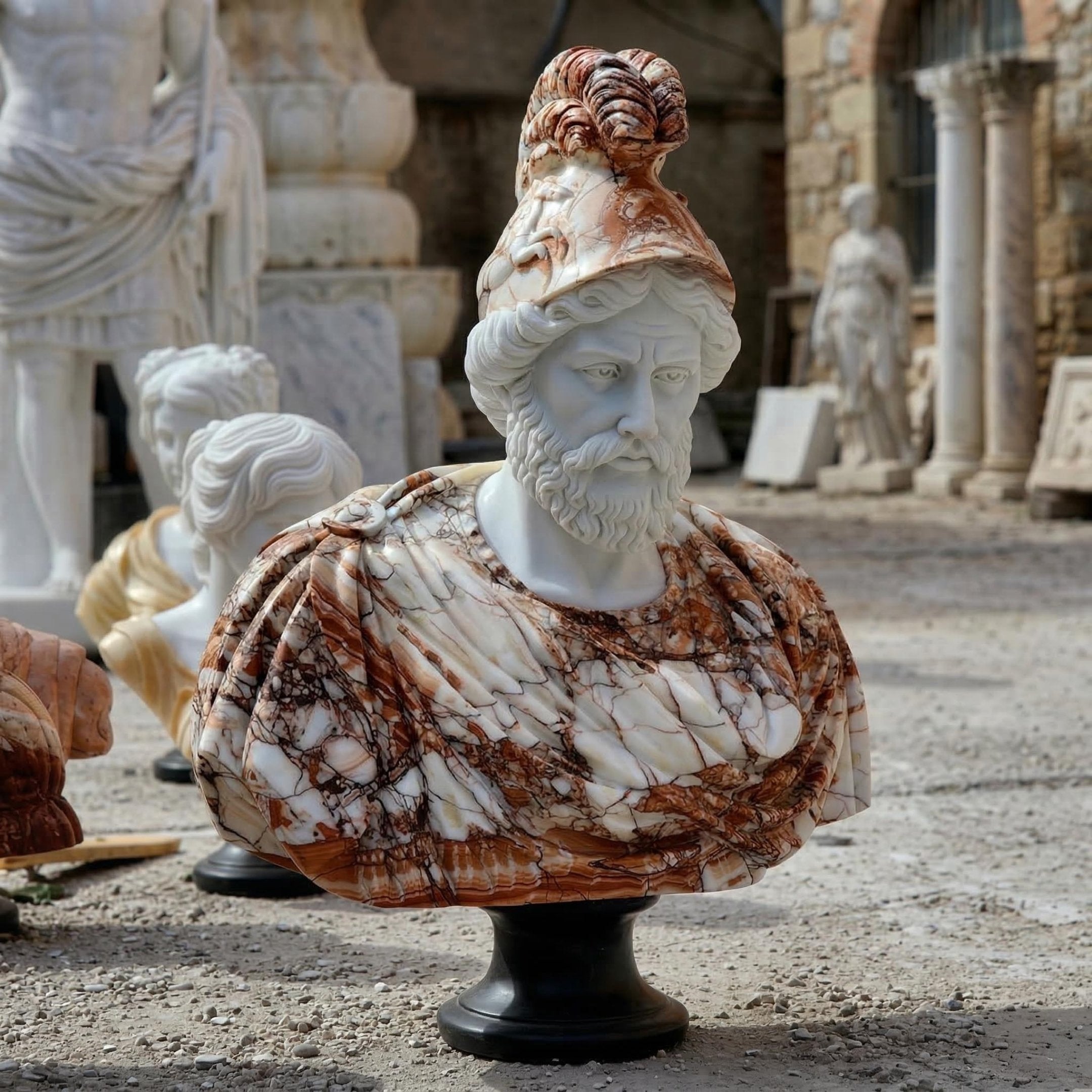 The Bearded Male Marble Bust Sculpture - 90cm by Giant Sculptures features an ancient warrior in a plumed helmet and armor, crafted from white and brown natural marble and displayed outdoors on a black pedestal among other statues.