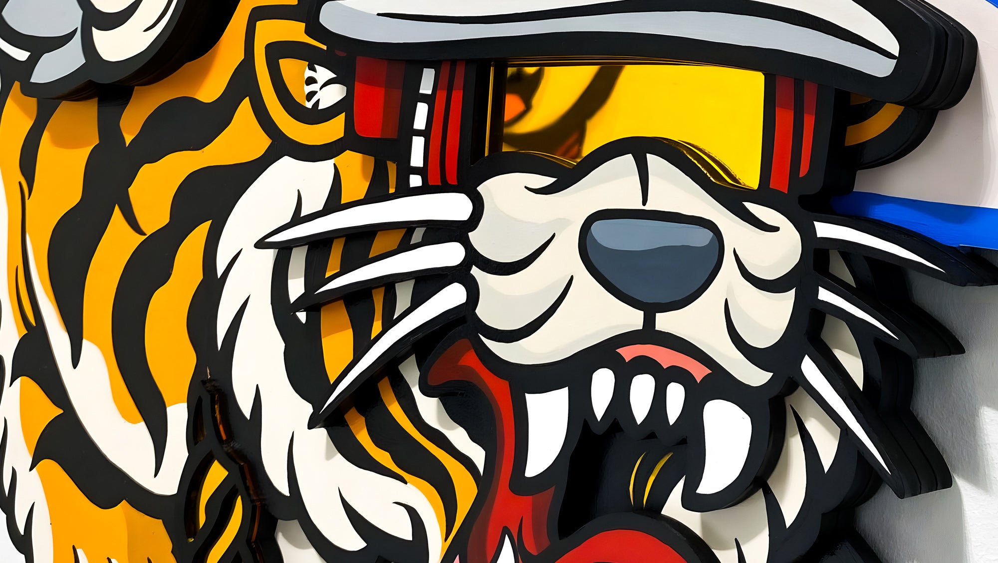 Illustration of a stylized tiger wearing sunglasses with a fierce expression. The design features bold black outlines, visible fangs, and vibrant orange, black, and white stripes, adding a dynamic, cartoonish feel to the artwork.