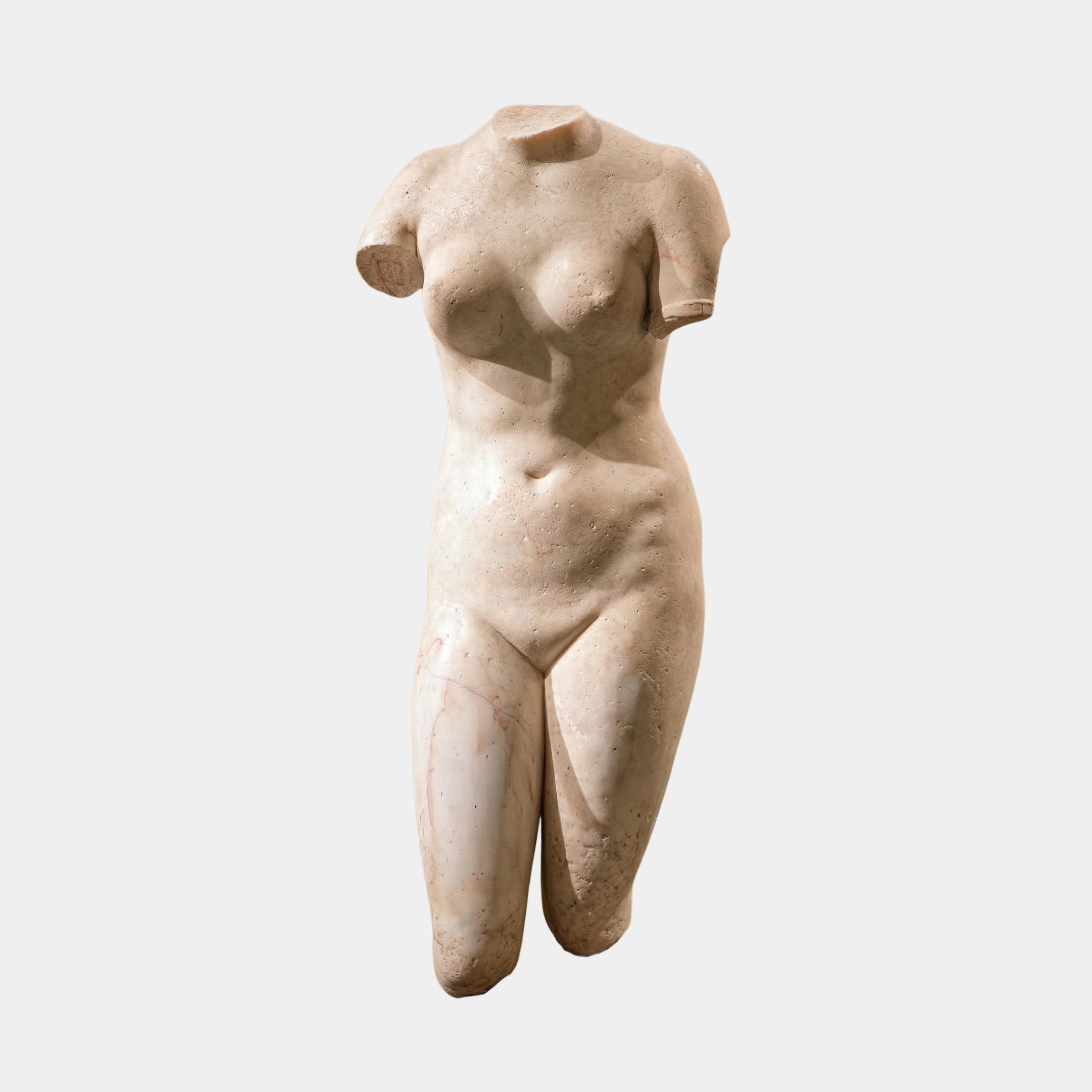 The Female V2 Marble Torso Sculpture - 130cm by Giant Sculptures is a headless, armless female form with intricate curves and muscle detail, its weathered marble surface showcased against a plain white background.
