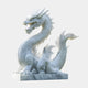 The Mystical Dragon White Marble Outdoor Sculpture by Giant Sculptures features intricate scales and sharp claws. With a long, curved body, an expressive face, and an open mouth, it rests on a square marble base against a light gray background, embodying timeless artistry.