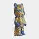 The Inside Appears Outside 2 Bear Sculpture (50cm) by Giant Sculptures features blue with swirling yellow and orange stripes, abstract green accents, and a creative style inspired by Jirayu Tantrakul. It stands upright on a plain white background.