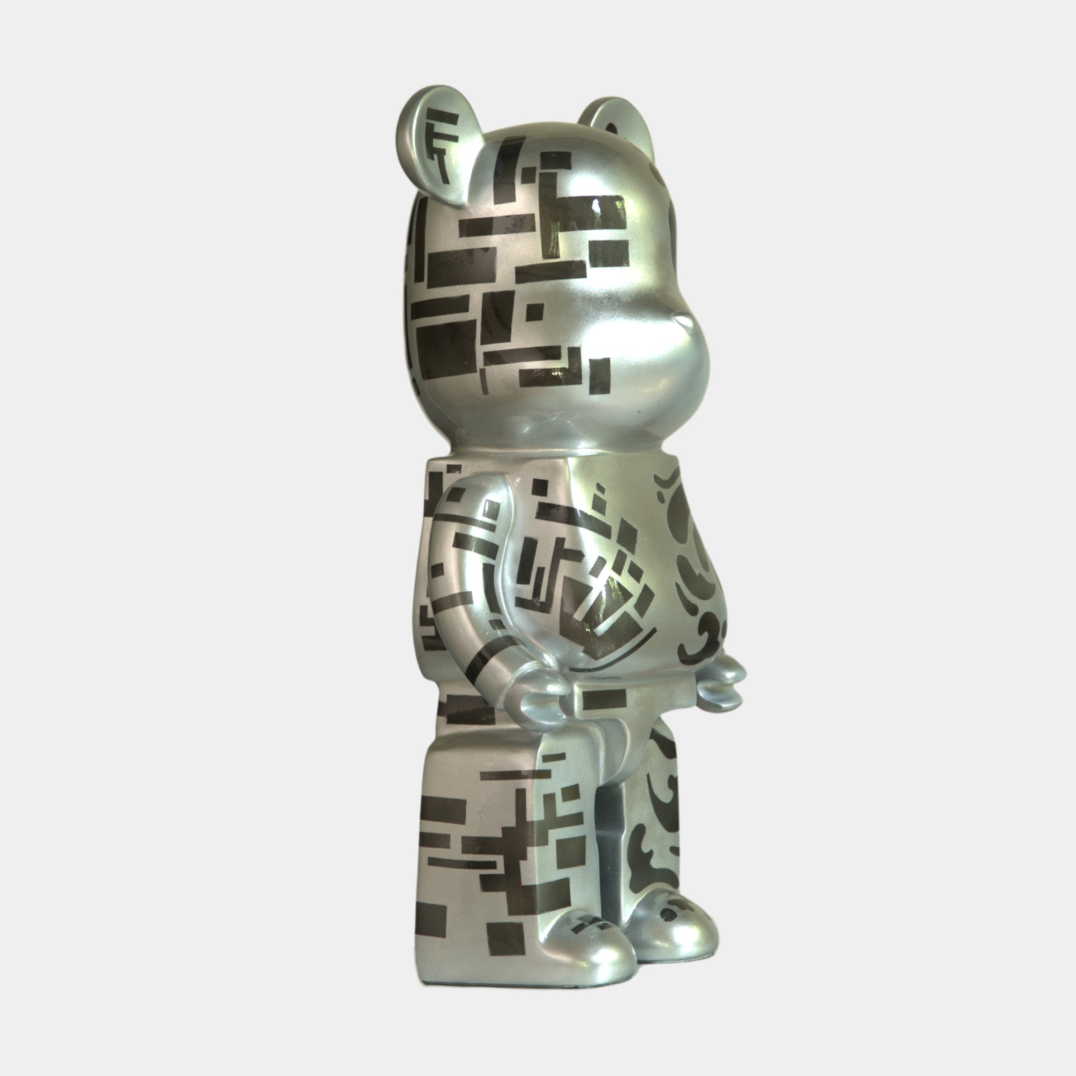 The Inside Appears Outside 3 Bear Sculpture (50cm) by Giant Sculptures features a mirror-like silver resin finish with black geometric and abstract patterns, standing upright against a plain white background.