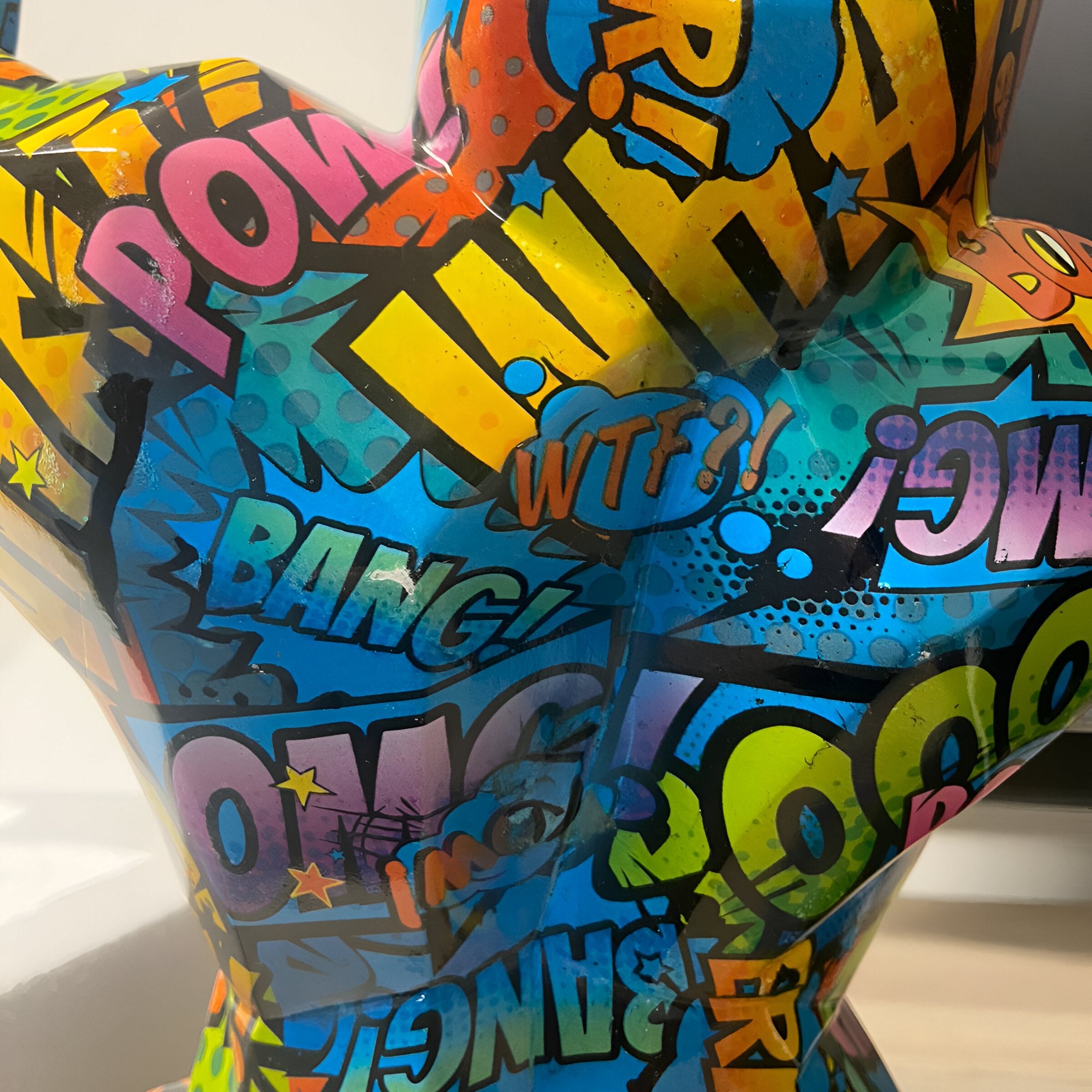 The Pop Art Gorilla Sculpture - 50cm (Ex Display) by Giant Sculptures features comic-book style words—POW!, OMG!, BANG!, WOW!, WTF?!—in bold, vibrant fonts on a glossy finish, making it ideal for contemporary decor.