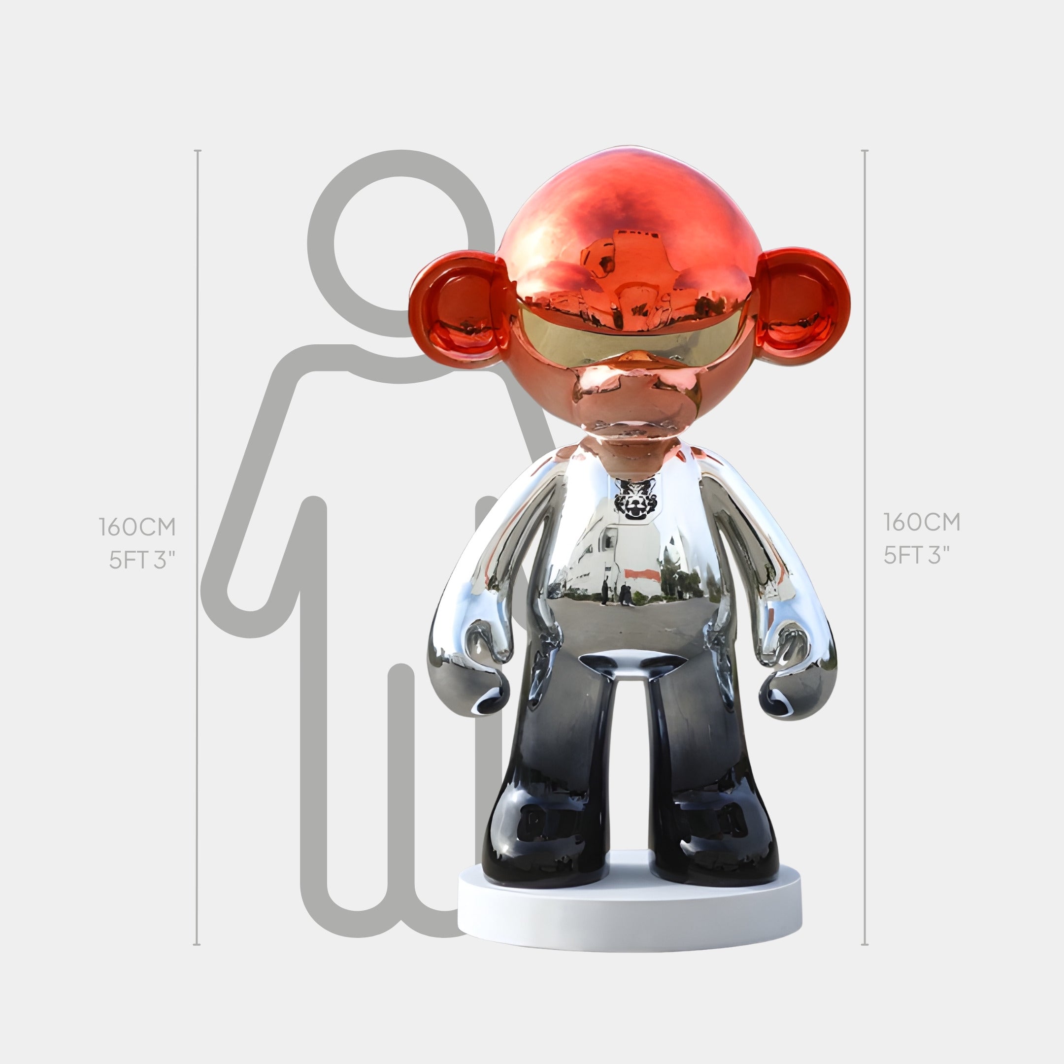 The Scarlet Chrome Monkey Sculpture - 160cm by Giant Sculptures features a shiny chrome finish with a red head, stands 160 cm tall on a white base, and is displayed next to a gray human outline of equal height for scale.