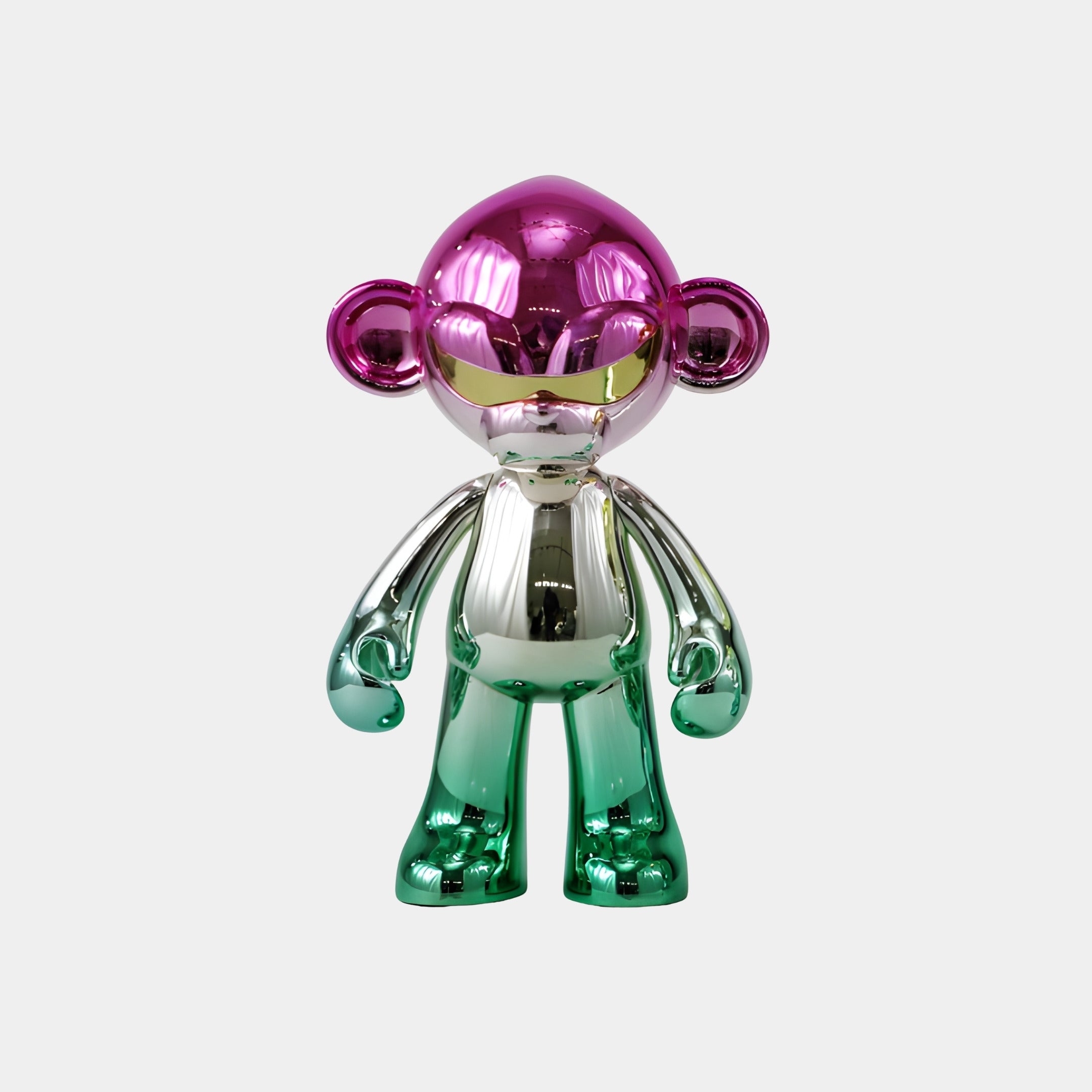 The Giant Sculptures Orchid Green Chrome Monkey Figure - 35cm features a shiny mirror finish with a pink head and ears, silver torso, and orchid green chrome arms and legs, standing out against a plain white background.