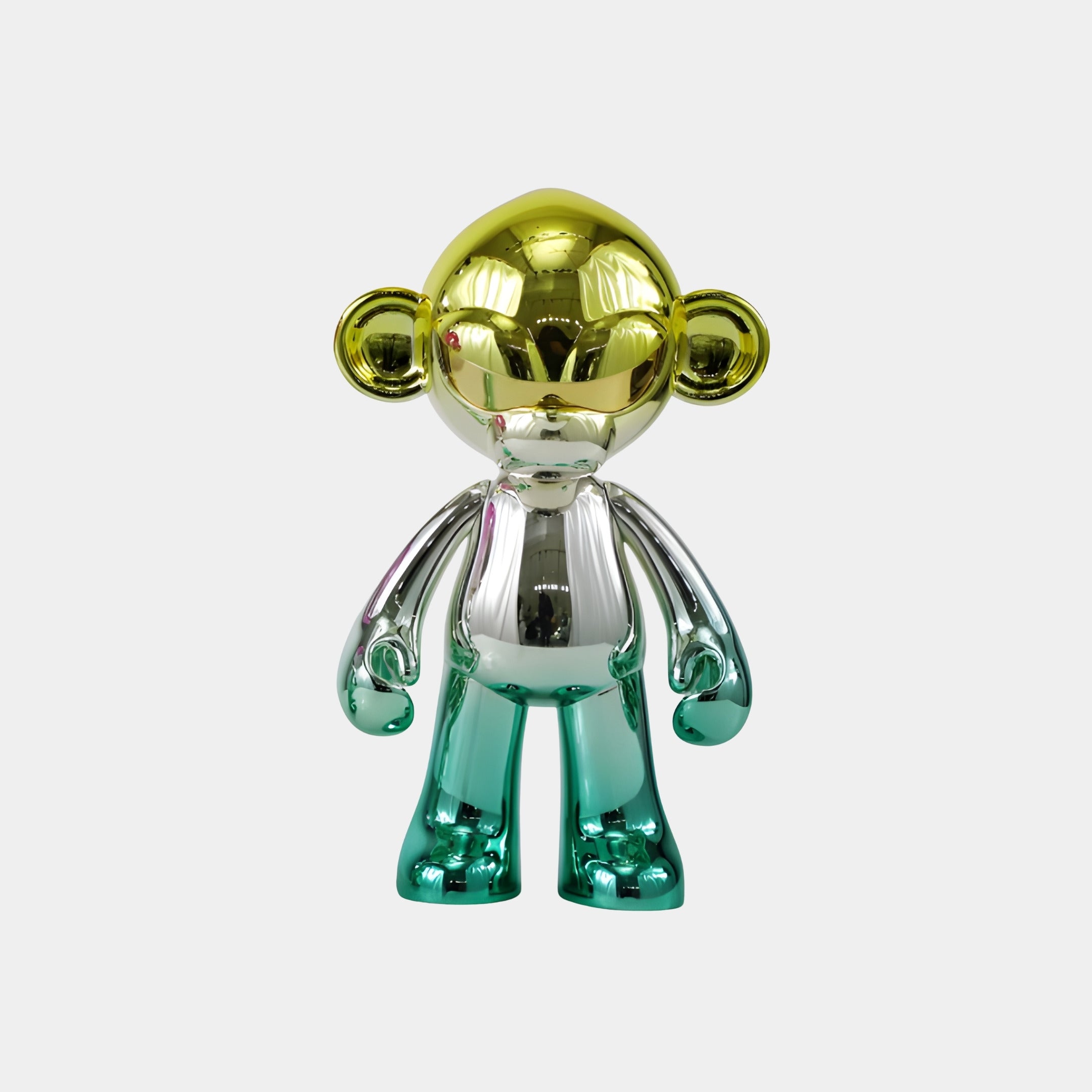 The Aurora Green Chrome Monkey Figure (35cm) by Giant Sculptures stands upright with a gold head and ears, silver torso and arms, and teal legs and feet—a chrome-plated collectible with a striking mirror finish.